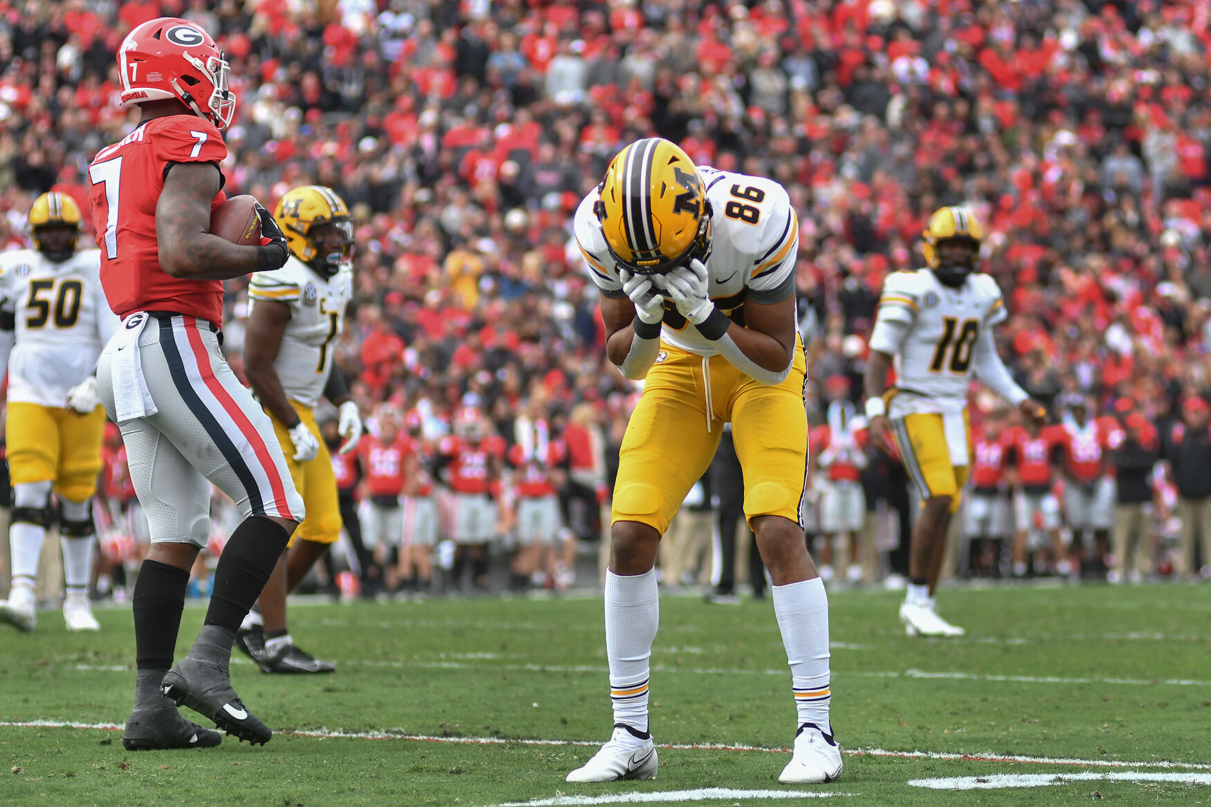 Tauskie Dove covers his face during the game against Georgia